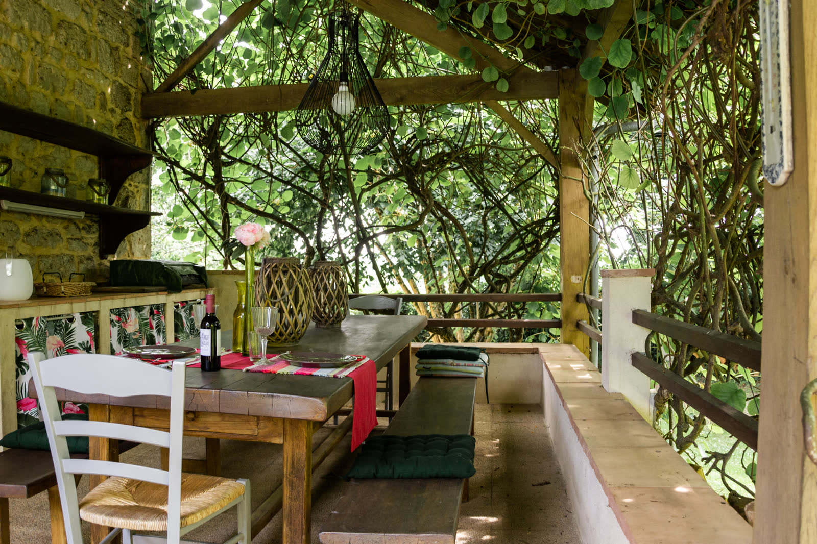 The long table set under the vines